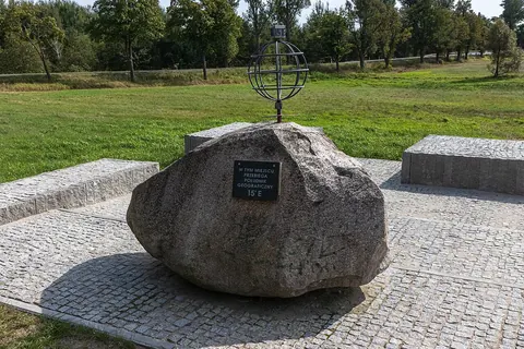Roca con placa y globo metálico del meridiano 15 este en Jasień